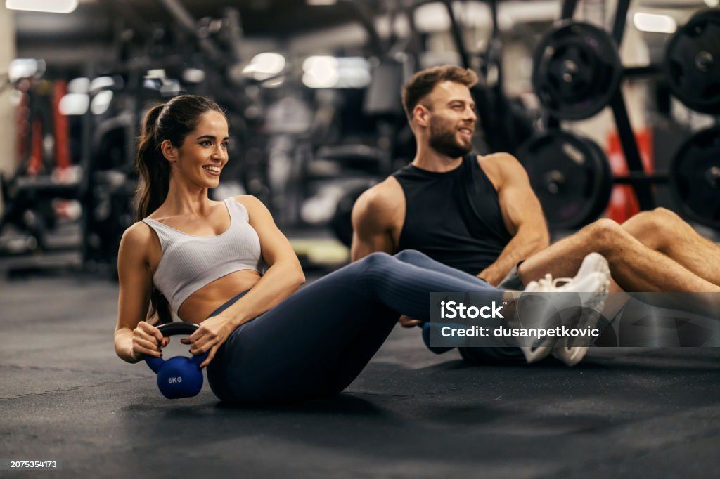 Seated kettlebell twist on a gym floor