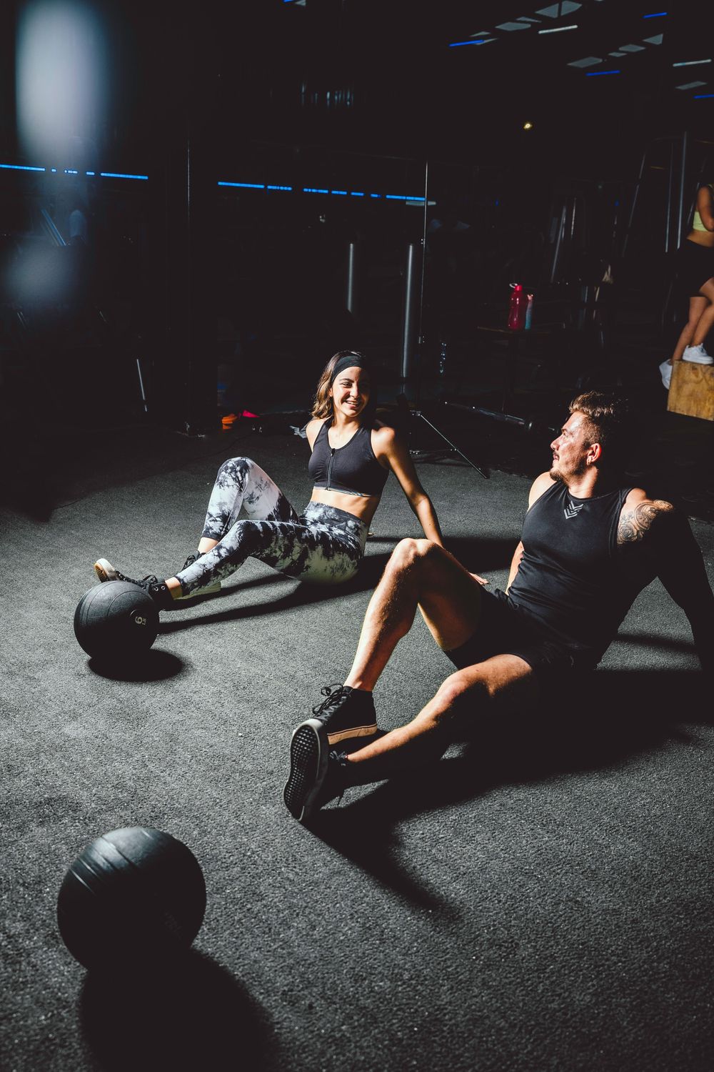 Training partners taking a break on the gym floor